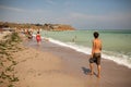 Tourists walking on the beach