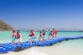 Tourists walking on blue pontoon to the beach at Coral Island P