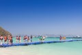 Tourists walking on blue pontoon to the beach at Coral Island P