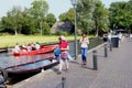 Chinese tourists walking electric boat canal, Giethoorn, Netherlands