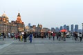 Tourists walking in the Bund, the most scenic spot in Shanghai. On background the most famous Chinese skyscrapers Royalty Free Stock Photo