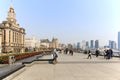 Tourists walking in the Bund, the most scenic spot in Shanghai. On background the most famous Chinese skyscrapers Royalty Free Stock Photo