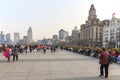 Tourists walking in the Bund, the most scenic spot in Shanghai. On background the most famous Chinese skyscrapers Royalty Free Stock Photo