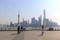 Tourists walking in the Bund, the most scenic spot in Shanghai. On background the most famous Chinese skyscrapers Royalty Free Stock Photo