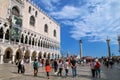 Tourists walking by Doge`s Palace on Piazzetta San Marco in Veni