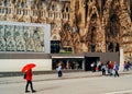 Tourists walking in front of Sagrada Familia