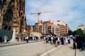 Tourists walking in front of Sagrada Familia