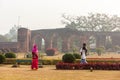 Tourists walking in the gardens of the ancient ruins of the Adina Masjid mosque in the