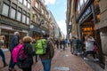 Tourists walking on Kalverstraat - main shopping street of Amsterdam