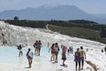 Tourists walking through the man-made baths built at Cotton Castle at Pamukkale in Turkey.