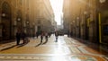 Tourists walking in Milan shopping center at sunny day, Italian architecture