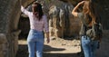 Tourists walking near ancient temple roman architecture in open air museum