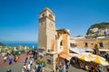 Tourists walking near clock tower on Piazza Umberto, knows as La Piazzetta, Capri Island, Italy