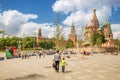 Tourists walking near Red square on a background of a St. Basil`s Cathedral Royalty Free Stock Photo