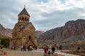 Tourists walking near Surb Astvatsatsin church at Noravank monastery Complex, Armenia