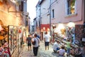 Tourists walking next to displayed souvenirs in Rovinj