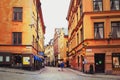 Tourists walking on the old cobble streets in the market in Gamla Stan, the old town of Stockholm in Sweden