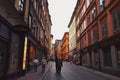 Tourists walking on the old cobble streets in the market in Gamla Stan, the old town of Stockholm in Sweden