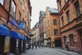 Tourists walking on the old cobble streets in the market in Gamla Stan, the old town of Stockholm in Sweden