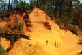 Tourists walking over ochre rocks near French Roussillon Royalty Free Stock Photo