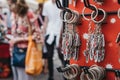 Tourists walking past a stand with souvenir key chain on sale at