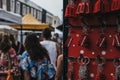 Tourists walking past a stand with souvenir key chain on sale at Royalty Free Stock Photo