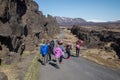 Tourists walking in a rift in Thingvellir National Park, Iceland