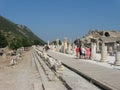 Tourists walking among ruins of the ancient city Ephesus