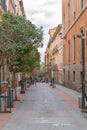 Tourists walking through the streets of the beautiful and pretty district in Madrid in a sunny day of Spring Shortly before a viru