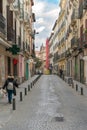 Tourists walking through the streets of the beautiful and pretty district in Madrid in a sunny day of Spring Shortly before a viru
