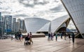 Tourists walking at the Sydney Opera house with close-up details of the roof in Sydney NSW Australia Royalty Free Stock Photo