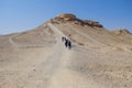 Tourists walking to the Zoroastrian Dakhma. Persian tower of silence. Yazd, Iran. Royalty Free Stock Photo