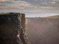 Tourists walking on top of cliff of Moher, Ireland, Rock structure is visible. Concept travel in Europe, Irish landmark Royalty Free Stock Photo