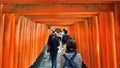 Tourists walking through the Torii Gates