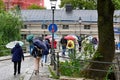 Tourists walking with umbrellas on city tour Orebro Sweden august 9 2023