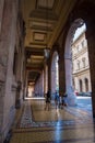 Tourists walking under the arches of Via XX Setembre, the main boulevard in Genoa