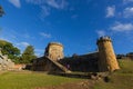 Tourists walking up to Guard Tower as a ruin on Settlement Hill Royalty Free Stock Photo