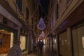 Tourists walking in a Venetian street with Christmas decorations at night