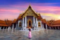 Tourists walking at Wat Benchamabophit or the Marble Temple in Bangkok, Thailand