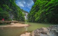 Tourists on a path along river in Wulong National Park