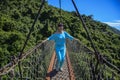 Tourists are walking on a wooden suspension bridge in the park of Yalong Bay Tropic Royalty Free Stock Photo