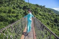 Tourists are walking on a wooden suspension bridge in the park of Yalong Bay Tropic Royalty Free Stock Photo