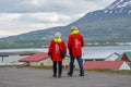 Tourists wandering around the streets of village of Hrisey in Iceland