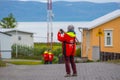 Tourists wandering around the streets of village of Hrisey in Iceland