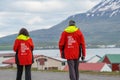 Tourists wandering around the streets of village of Hrisey in Iceland