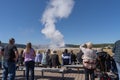 Tourists watch Old Faithful Yellowstone National Park