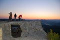 Tourists watch the sun rise on the mountain