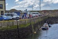 Tourists watching and feeding seals in Eyemouth in Scotland. 07.08.2015