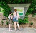 Tourists watching the map of Botanic Gardens in Singapore