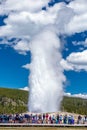 Tourists watching the Old Faithful erupting in Yellowstone National Park Royalty Free Stock Photo